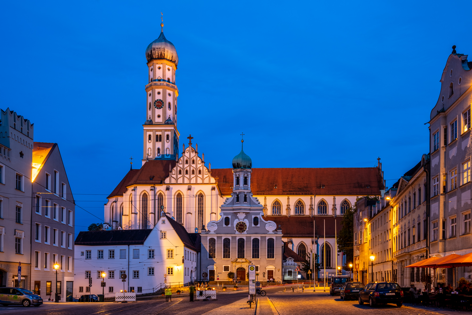 Basilica of SS. Ulrich and Afra, Augsburg, Bavaria, Germany. The catholic parish, one of the best examples of Gothic architecture in Germany, originated from the Roman tomb of St. Afra, which was martyred in 304. Its high bell tower with an "onion" dome, which dominates the city to the south, served as a prototype for the construction of numerous baroque towers of Bavaria. The church was officially elevated to the rank of imperial abbey in 1577 and in the anniversary 200 years later, Wolfgang Amadeus Mozart held and organ concert there.