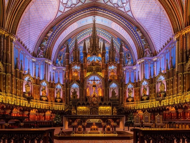 Interior of the Notre-Dame Basilica, located in the historic district of Old Montreal, in Montreal, Quebec, Canada. The interior of the basilica, built in Gothic Revival style, is impressive with vivid colors, stars and filled with hundreds of intricate wooden carvings and several religious statues. It was built between 1823 and 1829 after a design of James O'Donnell and it has become one of the landmarks of the city.
