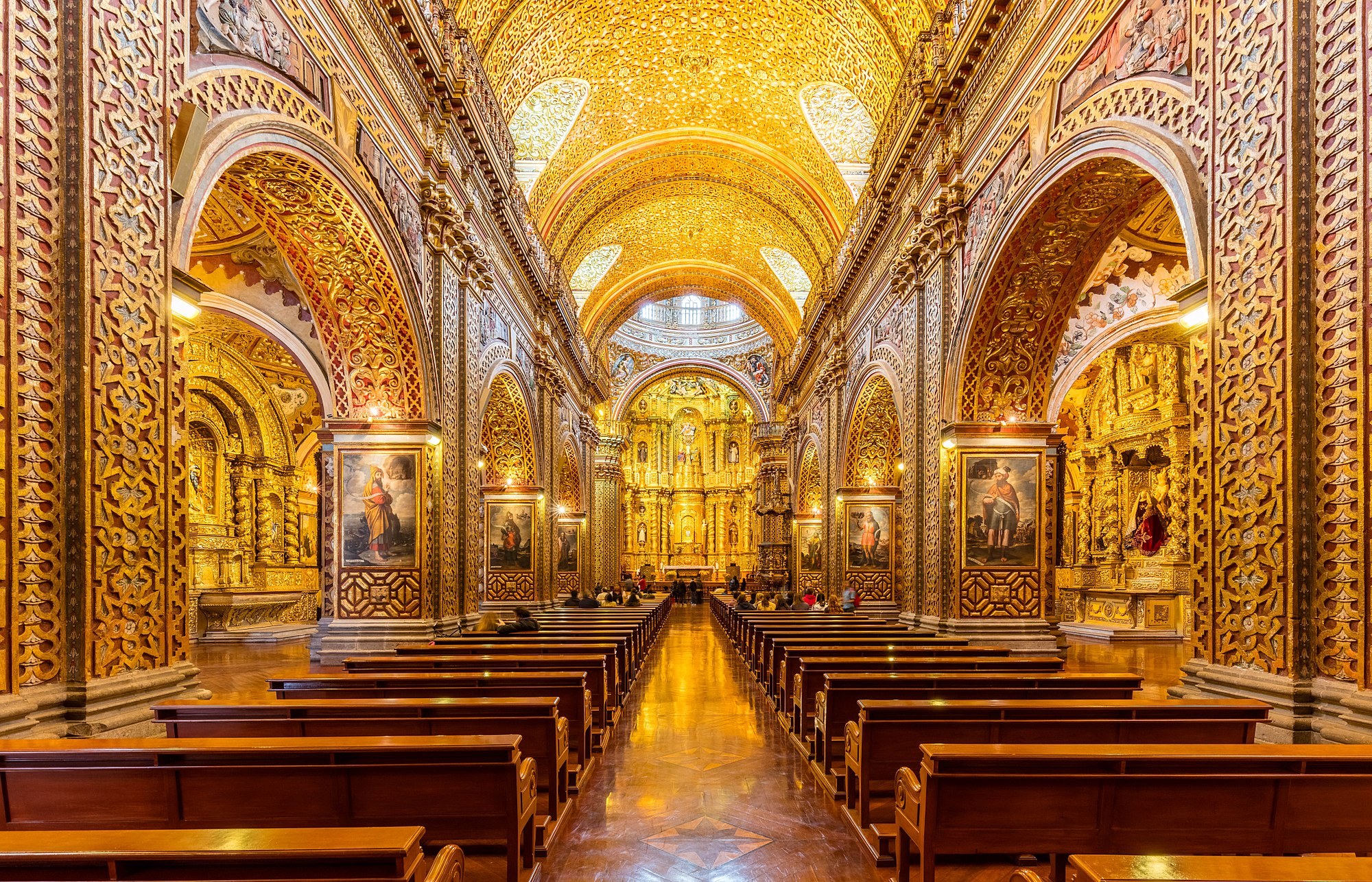 Main nave of the Church of the Society of Jesus (La Iglesia de la Compañía de Jesús), a Jesuit church in Quito, Ecuador. The exterior doesn't give an idea of the beauty of the interior, with a large central nave, which is profusely decorated with gold leaf, gilded plaster and wood carvings, making of it the most ornate church in Quito. The temple is one of the most significant works of Spanish Baroque architecture in America and considered the most beautiful church in Ecuador.