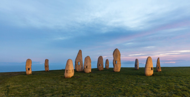 Family of Menhirs, Tower Park, La Coruña, Spain. The sculpture group, created in 1994, is work of artist Manolo Paz. The holes in the rocks are designed to frame different views of the park and the bay through them.