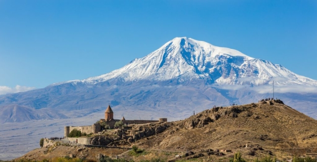 View of Khor Virap, an Armenian monastery and one of the most visited pilgrimage sites in Armenia located in the Ararat plain with the Mount Ararat in the background. Khor Virap's notability as a monastery and pilgrimage site is due to the fact that Gregory the Illuminator, religious leader who converted Armenia from paganism to Christianity in 301, becoming the first nation to adopt Christianity as its official religion, was initially imprisoned here for 14 years by King Tiridates III of Armenia. A chapel was initially built in 642 by Nerses III the Builder as a mark of veneration to Saint Gregory. Over the centuries, it was repeatedly rebuilt and the current appearance dates from 1662.