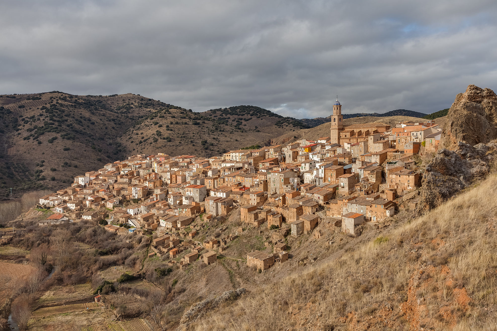 View of the small village of Moros, province of Zaragoza, Aragon, Spain. The whole village of Moros lies on a hill, with the most relevant buildings in the top (church and former town hall), the residences in the middle and the sheep pens at the bottom. The current population of Moros is 441 people (35% of the population one century ago, that's why many houses are abandoned).