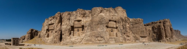 Panoramic view of the ancient Naqsh-e Rustam necropolis located about 12 km northwest of Persepolis, in Fars Province, Iran. The site includes rock reliefs of Achaemenid and Sassanid periods, 4 tombs of Achaemenid kings and a Cube of Zoroaster (far left). The reliefs are the oldest elements (the oldest one from 1000 BC) of Elamite origin. The tombs were carved out of the rock and belong (left to right) to Darius II (c. 423-404 BC), Artaxerxes I (c. 465-424 BC), Darius I (c. 522-486 BC) and Xerxes I (c. 486-465 BC). The Cube of Zoroaster belongs to the Achaemenid era (5th century BC) and its purpose is still unclear.