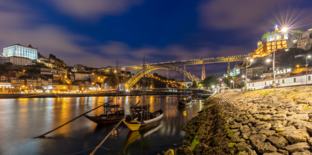View during the blue hour of the Dom Luís I Bridge and the city of Porto, Portugal. The bridge, built between 1881 and 1886 spans the Douro River to connect Porto with Vila Nova de Gaia.