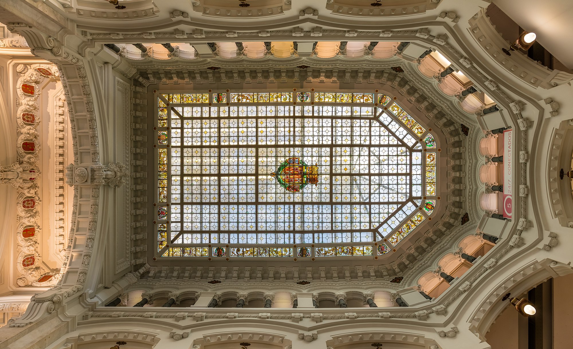 Skylight in the Cybele Palace or Palace of Communication, located on the Plaza de Cibeles, Madrid, Spain. The building, one of the landmarks of Spain's capital, was inaugurated in 1919 as headquarters of the Spanish postal and telecommunications service (Correos). The building was designed by Antonio Palacios and Joaquín Otamendi. Today the building is seat of the City Council.