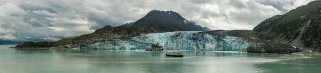 Safari Endeavour vessel (232 feet (71 m) long and with up to 88 guests + 37 crew members) in front of the Lamplugh Glacier, Glacier Bay National Park, Alaska, United States.