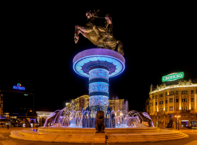 The Warrior on a Horse statue is one of the main symbols of the [[:en:Skopje 2014|Skopje 2014]] project and is located in the center of [[:en:Macedonia Square, Skopje|Macedonia Square]] in [[:en:Skopje|Skopje]], capital of the [[:en:Republic of Macedonia|Republic of Macedonia]]. Although it is not officially named for him, it is typically thought to depict [[:en:Alexander the Great|Alexander the Great]]. The statue was sculpted by Valentina Stefanovska and completed on September 8, 2011 to commemorate 20 years of the [[:en:History of the Republic of Macedonia|independence of the Republic of Macedonia]]. The bronze sculpture is 14.5 m tall and it sits on a cylindrical column, which itself is 10 m in height. The column consists of three large ivory sections containing reliefs, each separated by a thinner bronze ring. Each section contains reliefs. The column stands in a fountain and at the base of the column there are 8 bronze soldiers, each 3 m tall and 8 bronze lions, each 2.5 m tall.
