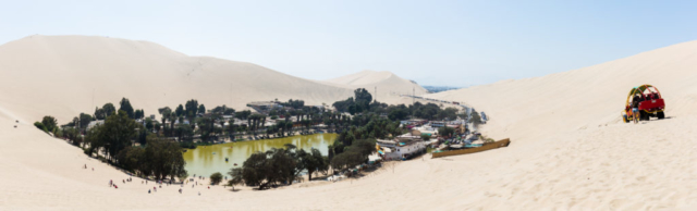 Huacachina oasis, Ica Region, Peru. The location has a population of 115 and is built around a natural lake in the desert and is a popular destination for sandboarding and buggy riding.