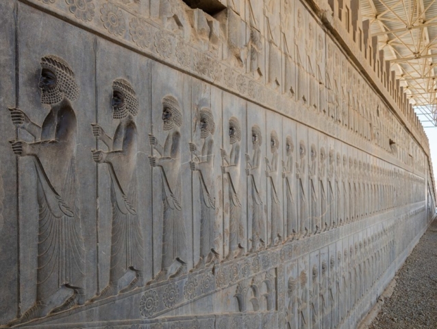 Bas-reliefs of palace guards at the monumental stairs of the Apadana in Persepolis, today Iran. The Apadana was the largest building on the Terrace at Persepolis and was most likely the main hall of the kings. The reliefs of the stairs show delegates of the 23 subject nations of the Persian Empire paying tribute to Darius I along with the here depicted guards. These reliefs are very valuable since the great detail of various of the delegates give insight into the costume and equipment of the various peoples of Persia in the 5th century BC.