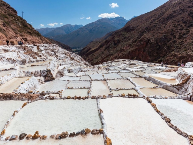 Salineras (salt evaporation ponds) in Maras, Peru. Salt has been harvested in Maras since the time of the Inca Empire. The site has around 3000 ponds of 5 square metres (54 sq ft) each. As the location is surrounded by salty mountains, subterrean water deposits the salty water in the ponds; the water evaporates due to the exposure to the sun. After approx. 1 month the level of salt reaches 10 centimetres (3.9 in) and is removed in sacks.