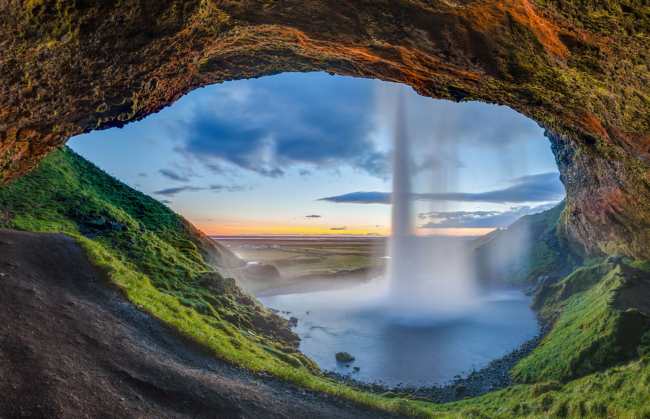 Sunset view from the back of the Seljalandsfoss waterfall, Suðurland, Iceland.