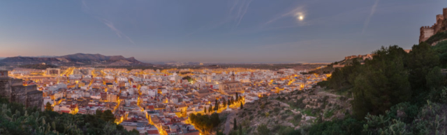View of the former roman city of Sagunto, Valencian Community, Spain, after sunset at the moon light from the hill where the castle is located.