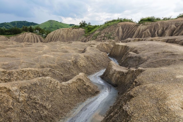 The Berca Mud Volcanoes are a geological and botanical reservation located close to Berca in Buzău County, Romania.