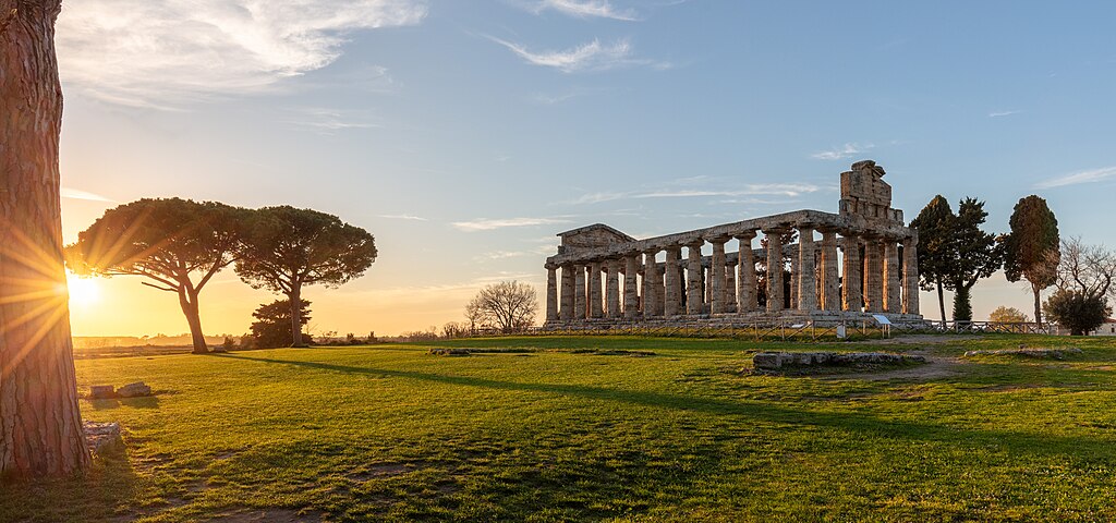 Temple of Athena, Paestum, Italy. The Greek temple of Magna Graecia was built around 500 BC on an artificial relief of the ground. It has a high pediment on the façade and a Doric frieze, adorned with metopes encased in sandstone, on slightly slender Doric columns. The interior of the wide pronaos contained six columns in the Ionic style (four frontal and two on each side), of which the bases and two capitals remain. These capitals burst from an ornate collar. This seems to be the first example of two architectural orders, Doric and Ionic, co-existing in a single building.